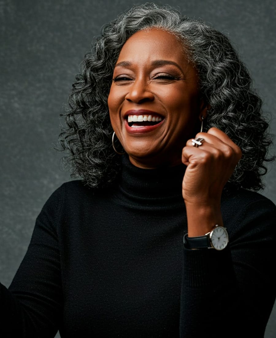 A confident, smiling woman with grey hair