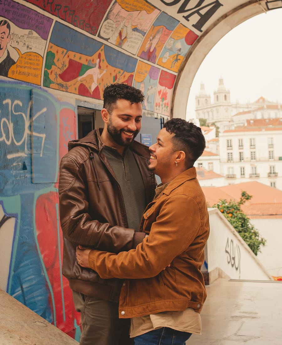 Two men embracing and smiling
