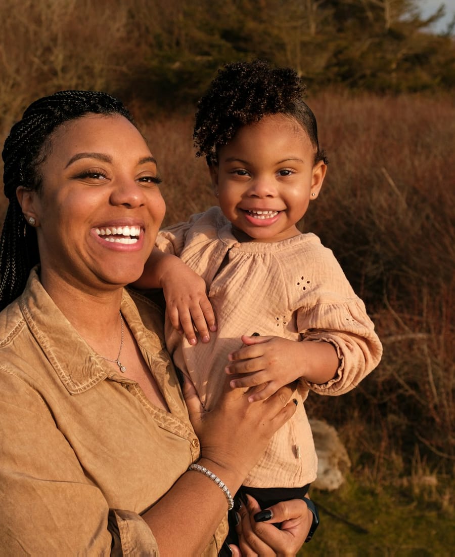 A mother laughing with her young daughter